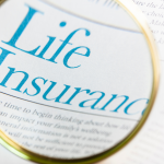 magnifying glass zoomed in on article about "life insurance"